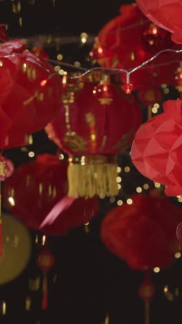 Vertical-Video-Studio-Shot-Of-Chinese-Lanterns-Celebrating-New-Year-With-Falling-Confetti-1